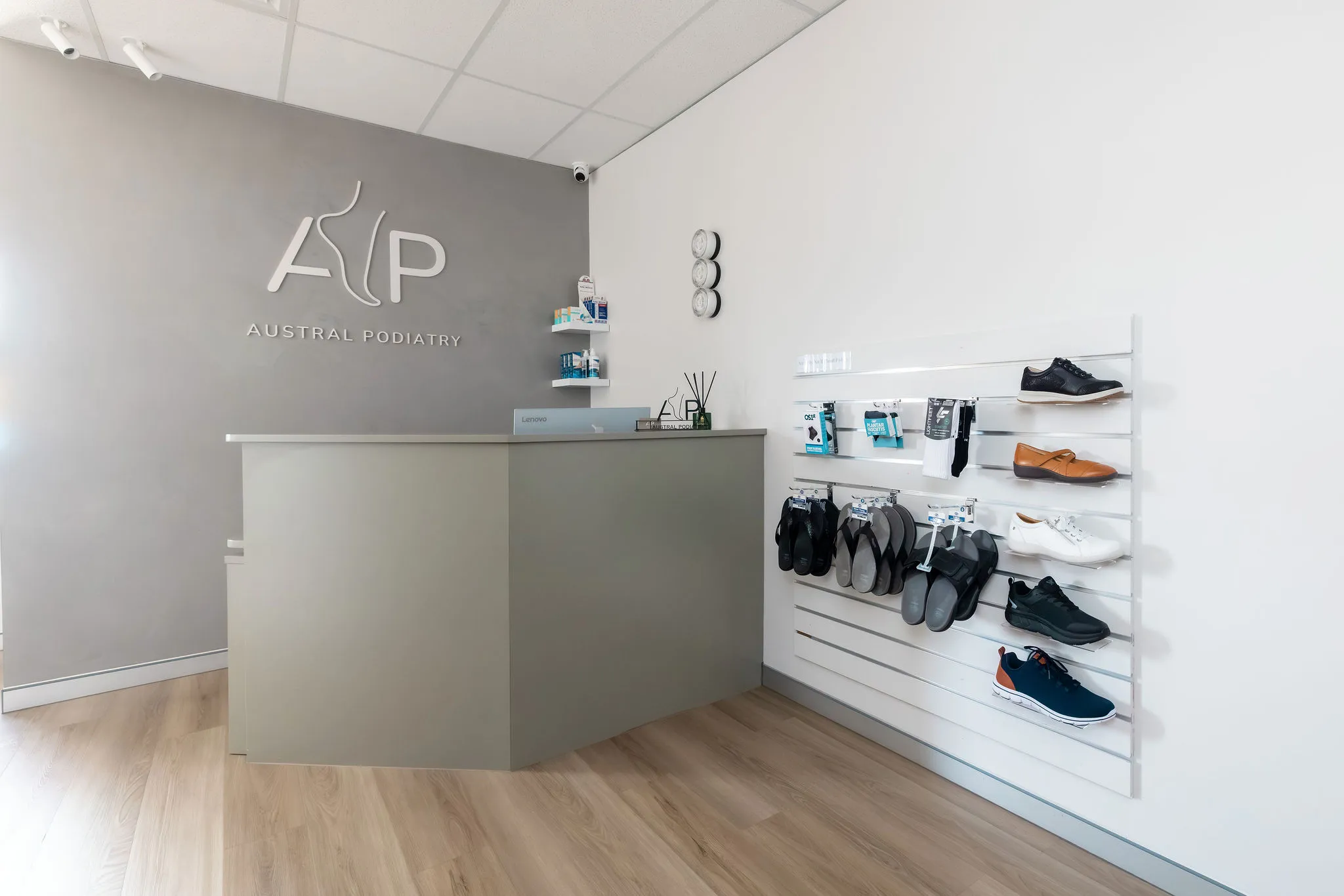 reception area at austral podiatry with desk and footwear display wall in austral, nsw