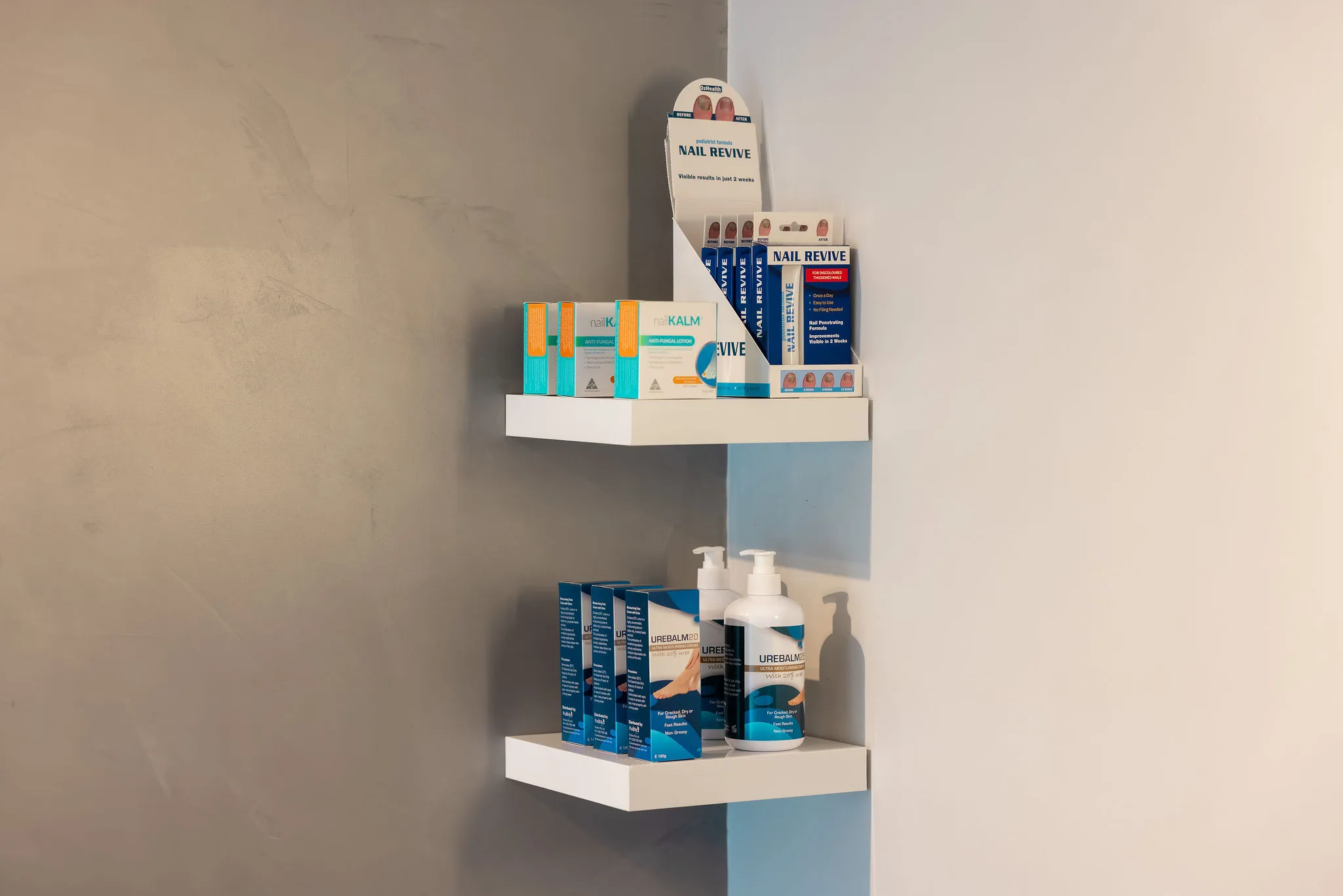 wall shelves displaying foot care products including nail revive and urebalm creams podiatry clinic austral, nsw
